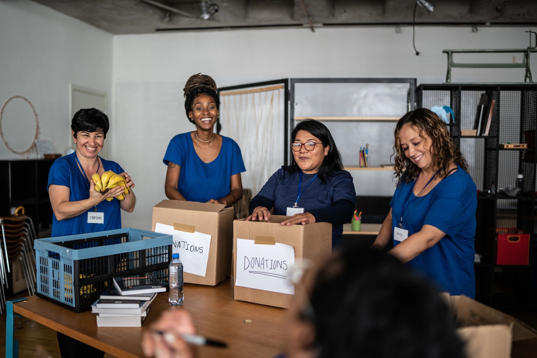 Volunteers arranging donations in a community center