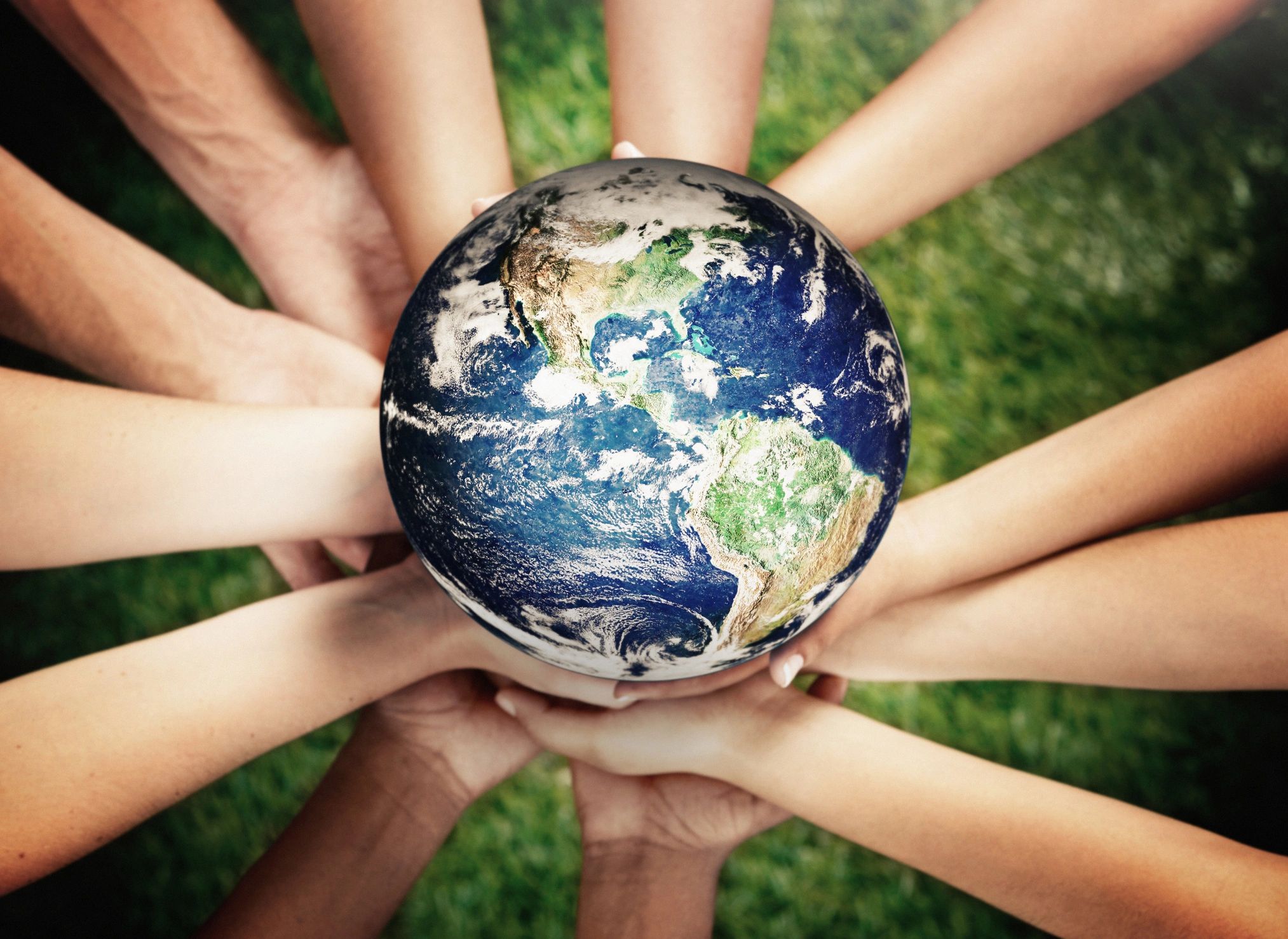 Hands supporting a globe, symbolizing community service and global impact