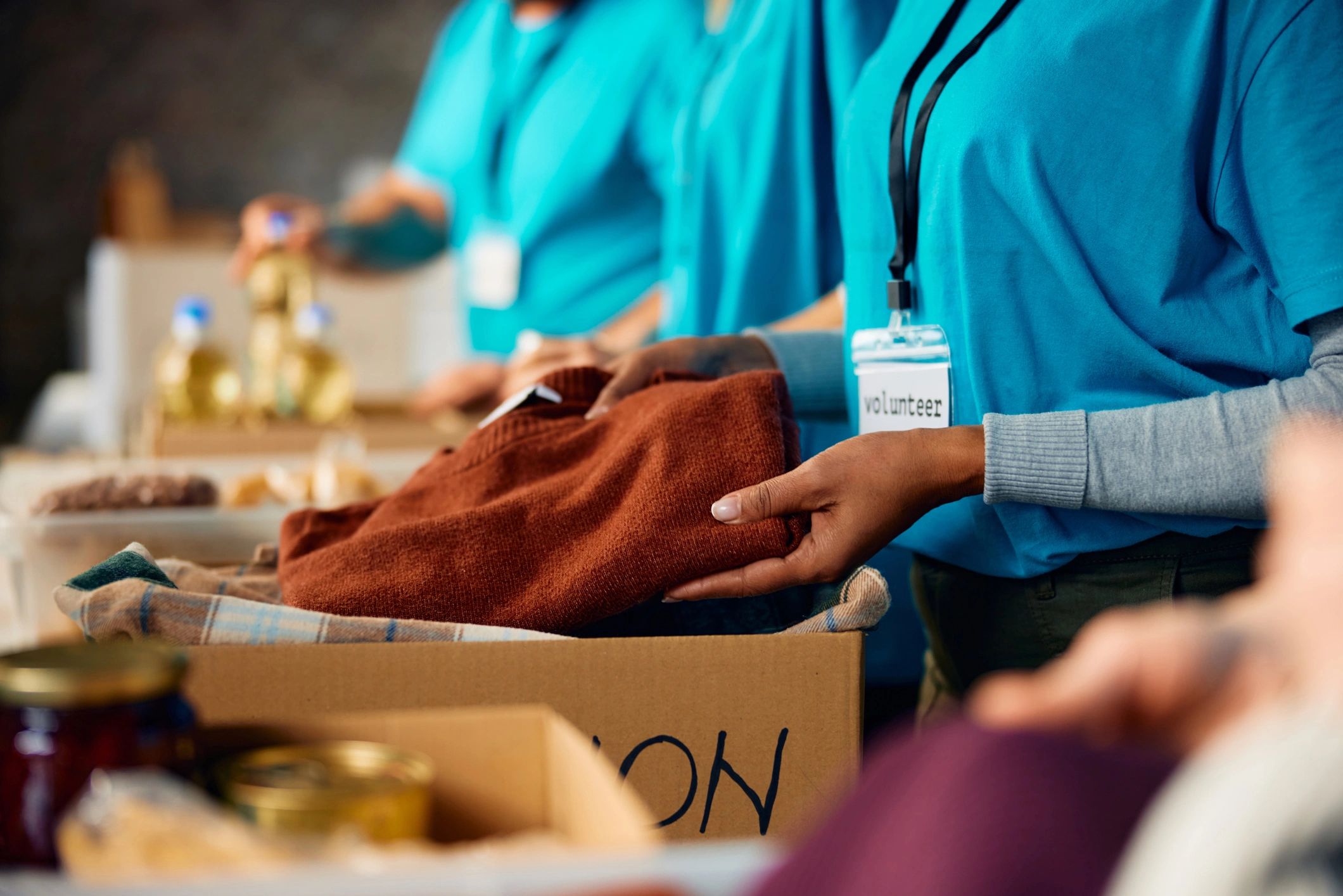 Volunteer packing donated clothes into boxes