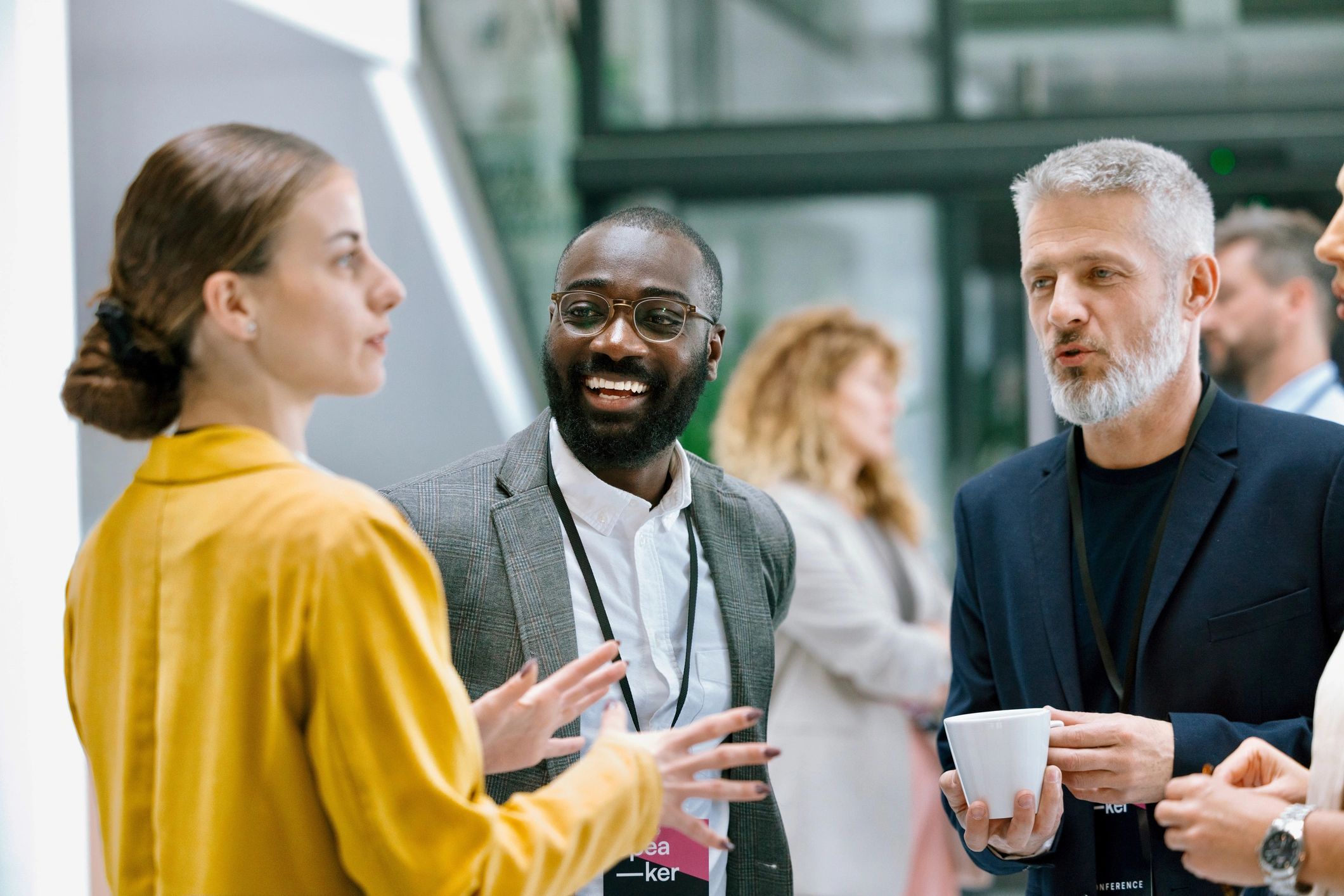 People chatting and smiling during an event intermission