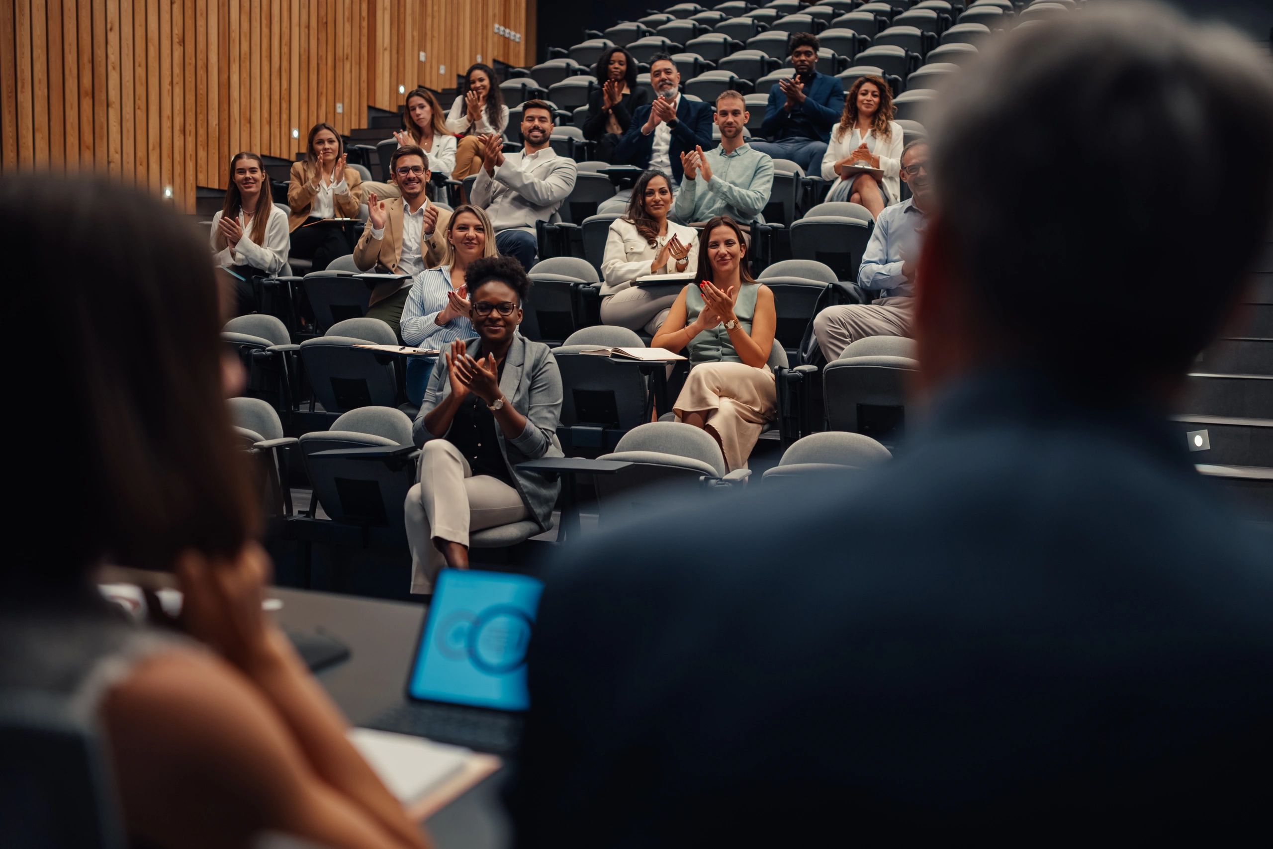 Community members applauding at a local event