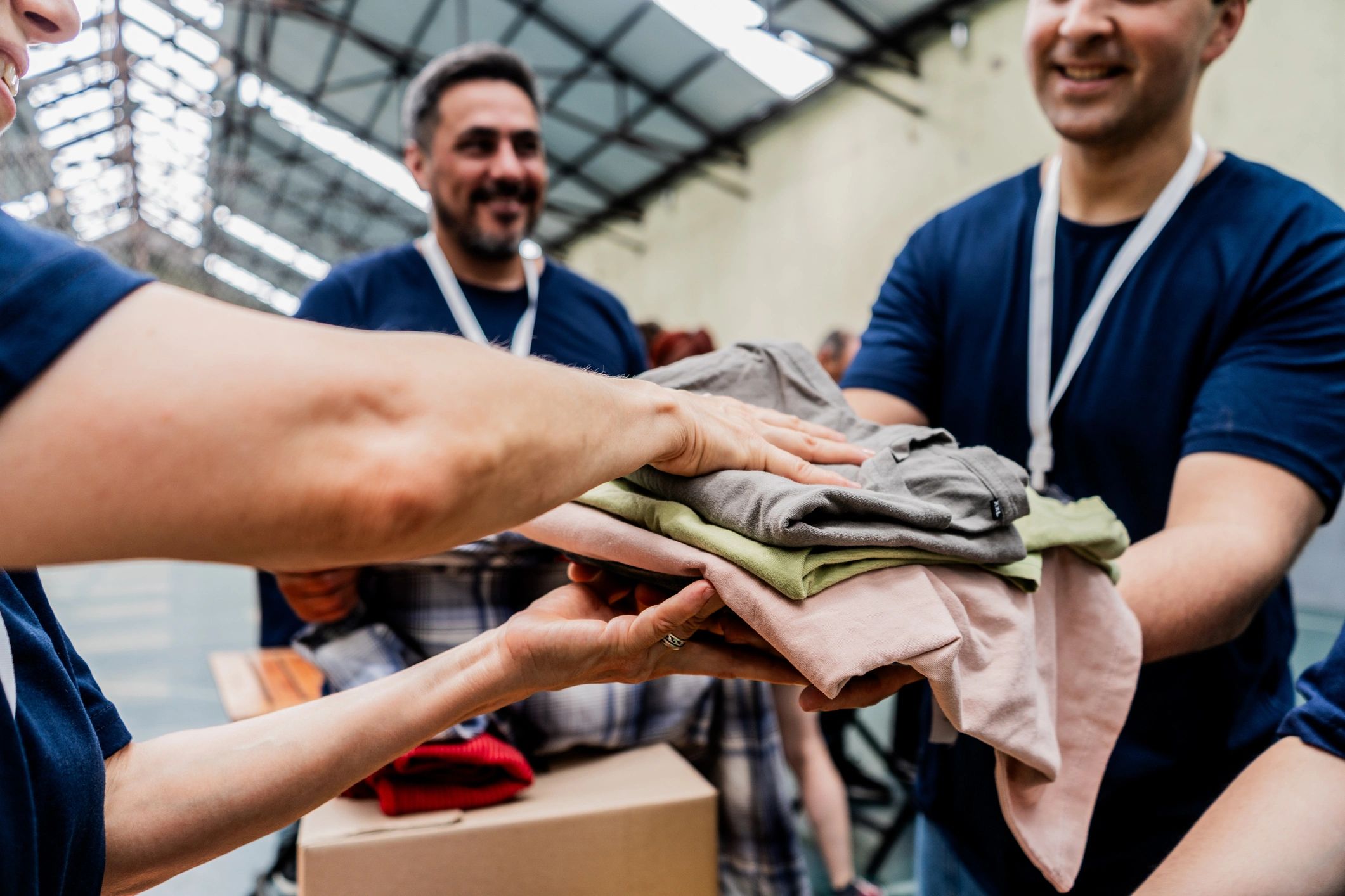Volunteers passing around clothes to donation
